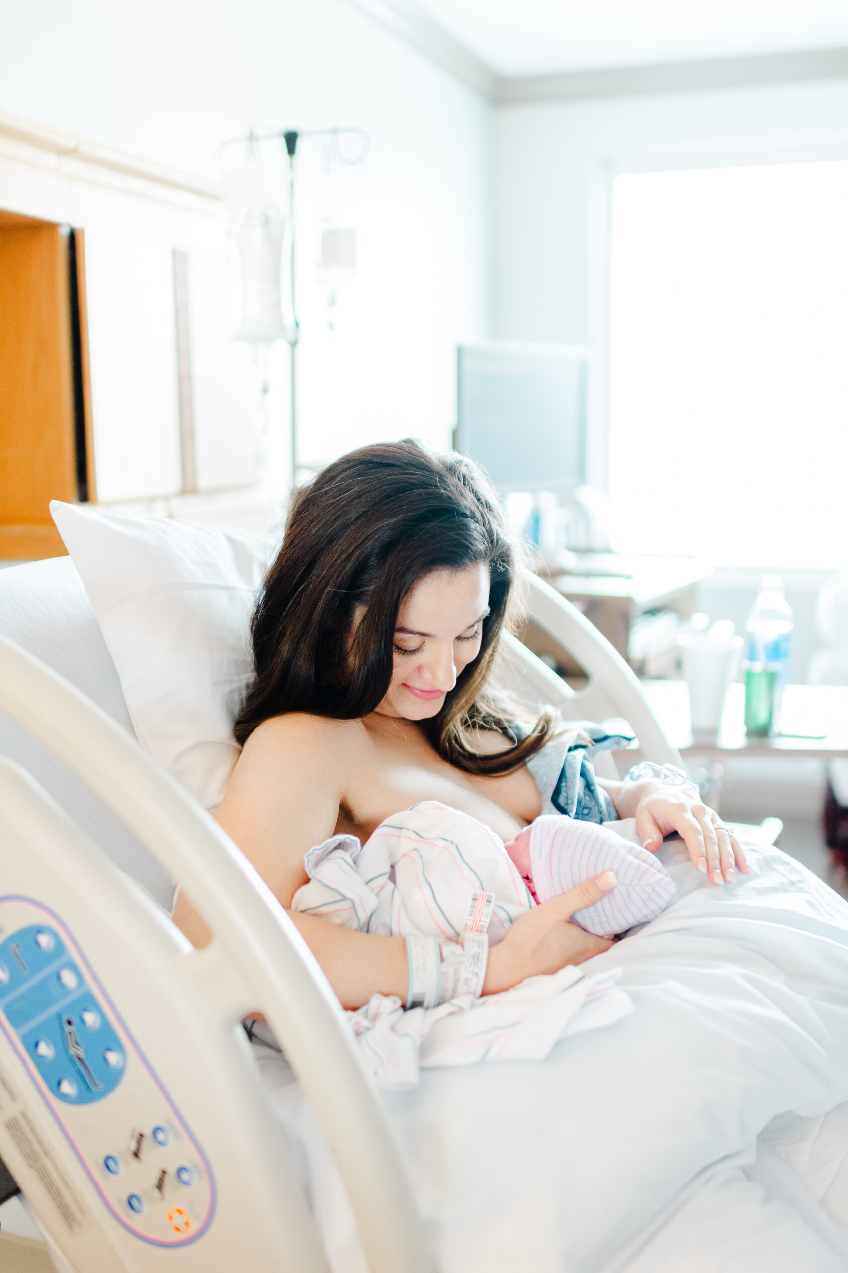 Mother cradling newborn baby during Golden Hour at Northwest Medical Center Bentonville, capturing their first bonding moments.