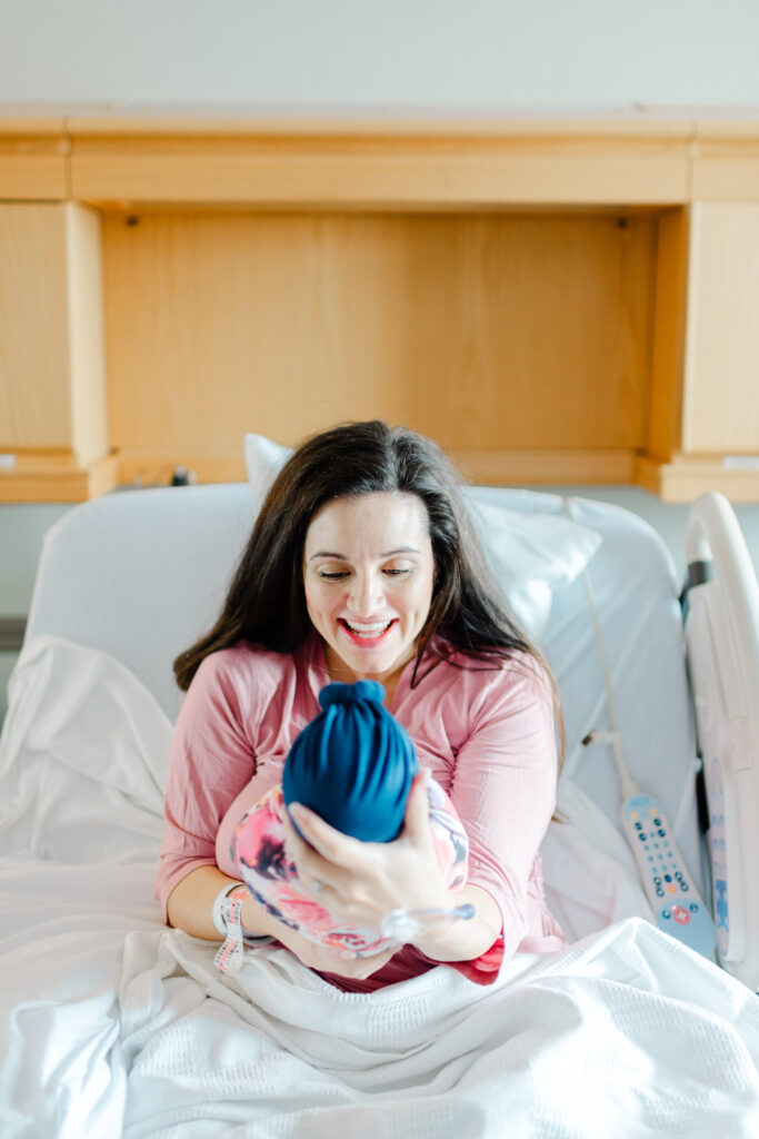 Mother cradling newborn baby during Golden Hour at Northwest Medical Center Bentonville, capturing their first bonding moments.