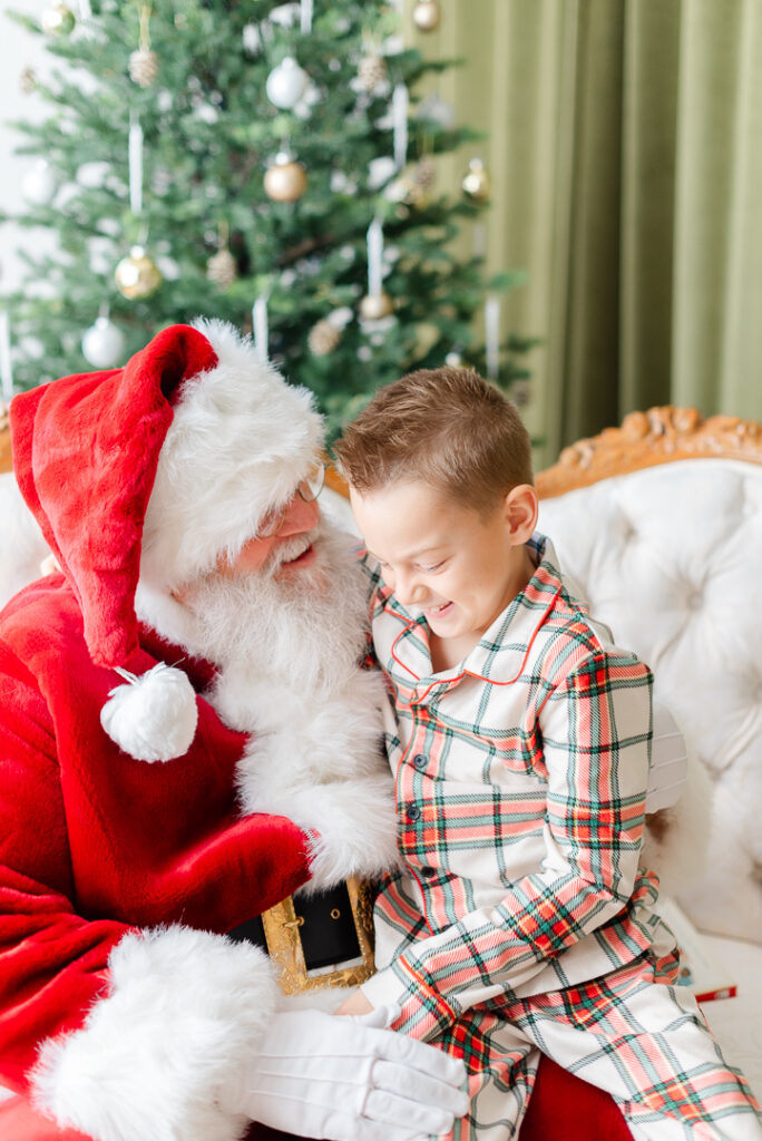Pictures with Santa: a boy sitting on Santa's lap.