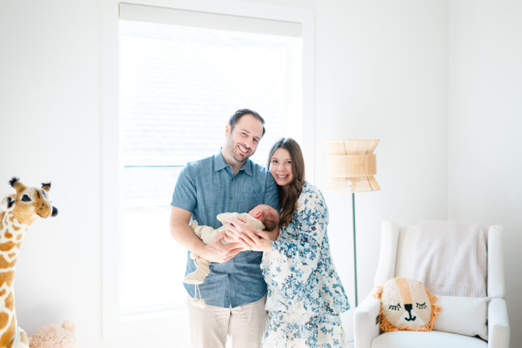 Newborn photographer documents sweet newborn moments in a beautifully decorated nursery.