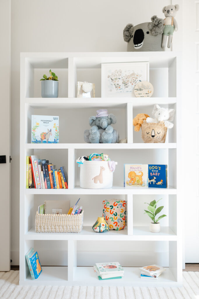 Natural light streams into the nursery as a newborn photographer photographs the decor.