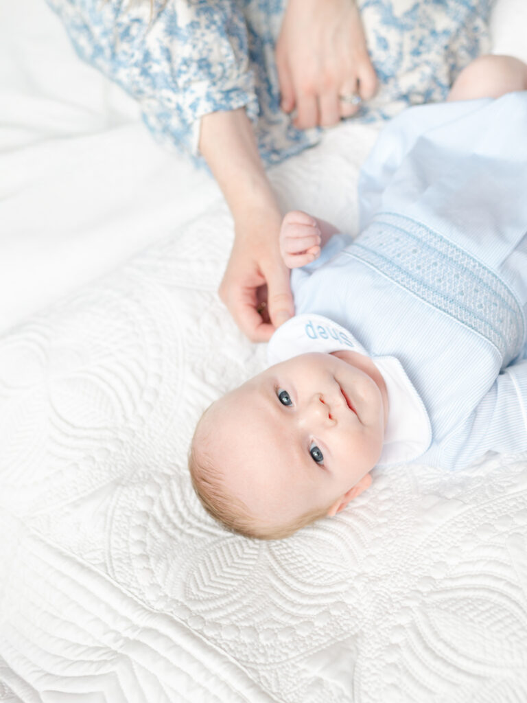 Eye-level close-up of a newborn baby’s face with eyes open, showing flattering angle for everyday baby photography.