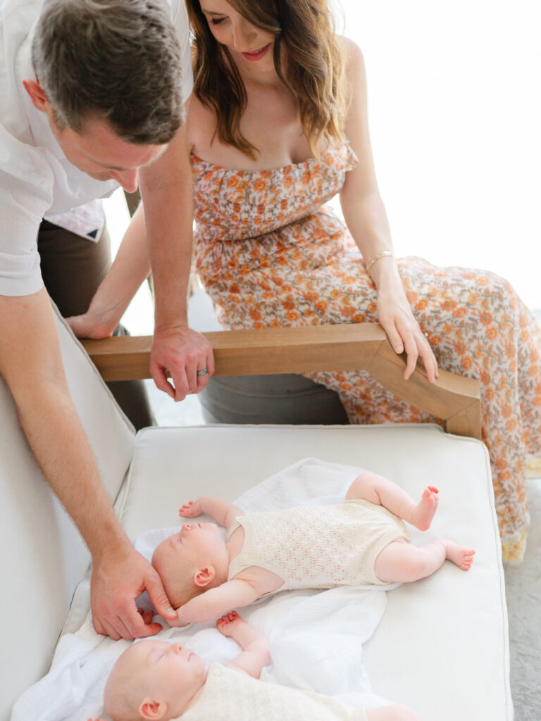 lifestyle newborn photography with twin girls on the patio