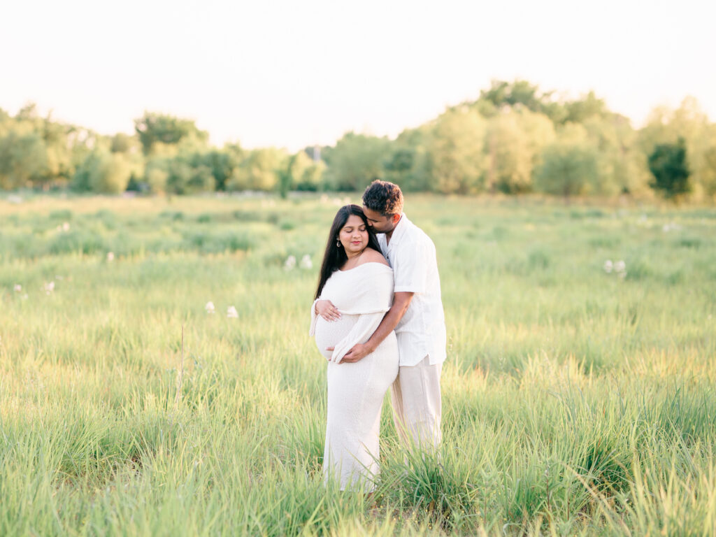 Joyful couple laughing together during maternity photography session at Osage Park in Bentonville