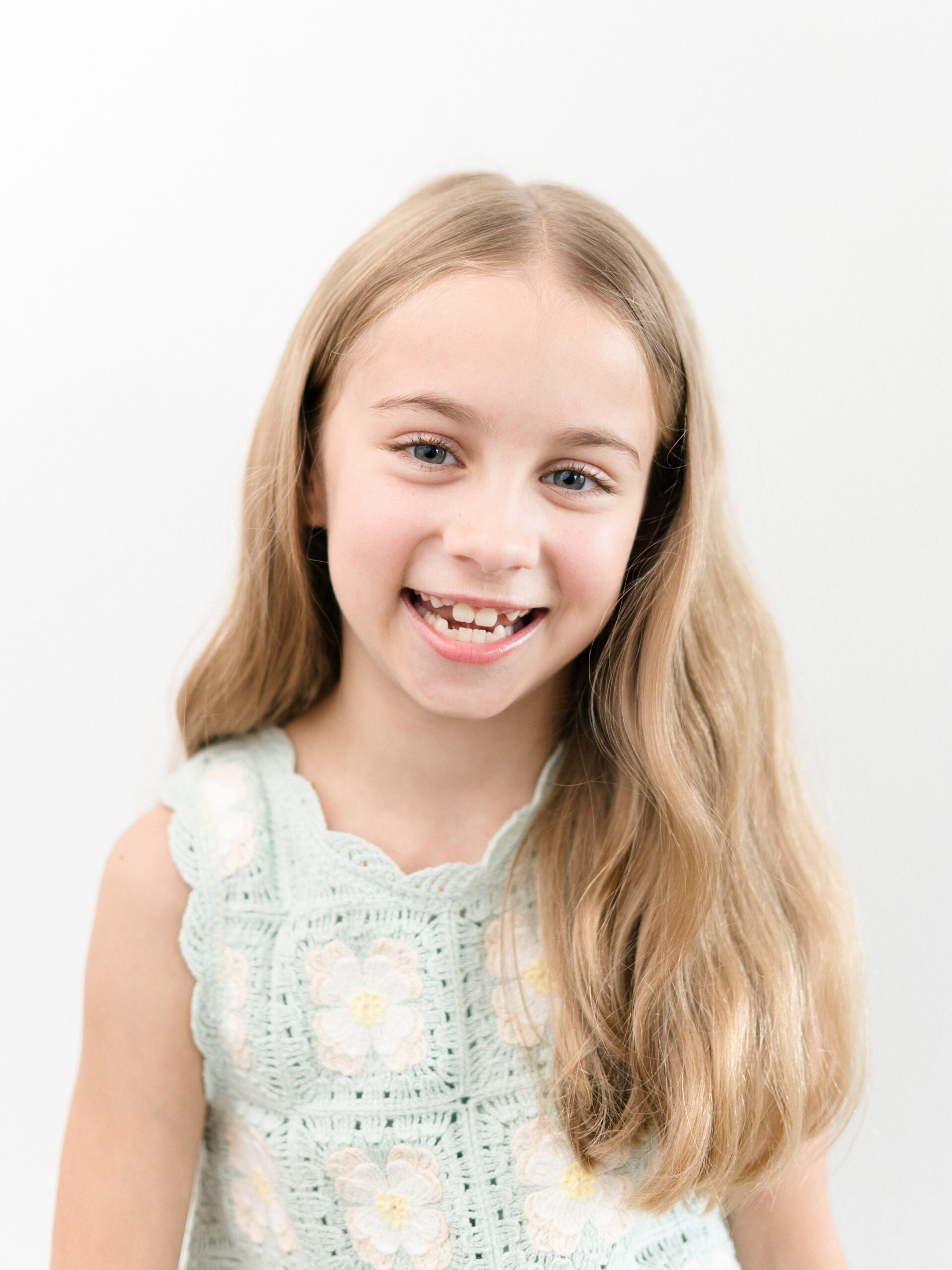 Smiling girl wearing a neutral shirt during school portraits by Northwest Arkansas Photographer Leslie Nice